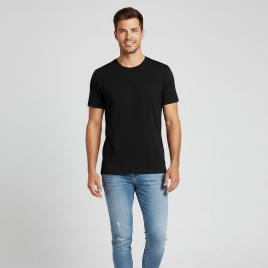 Man wearing a black t-shirt and light blue jeans on a gray background